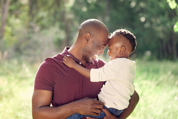 Father, son and forehead touch in outdoor for love, affection and support in nature to connect. Black family, trust and embrace for security in relationship, travel and hug on vacation in woods - Powered by Adobe