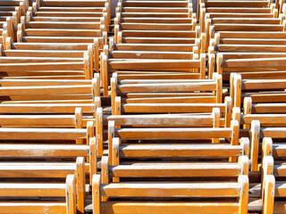 Group of stacked folding wooden chairs and grouped