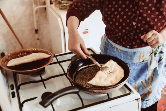 two elderly woman  is ooking pies in the kitchen