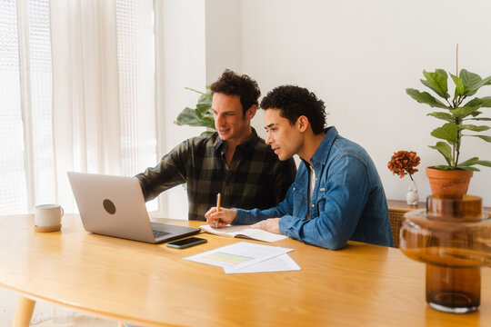 Cheerful Couple Paying Bill At Home