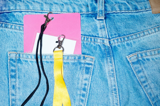 Denim jeans t and press pass/card hanging in lanyards with flashlight