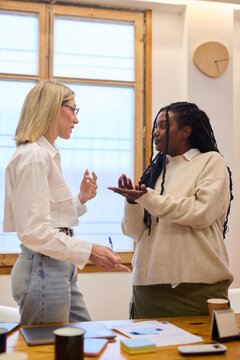 leader talking to intern in office