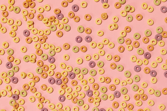 Colorful rings / loops breakfast cereal on pink background
