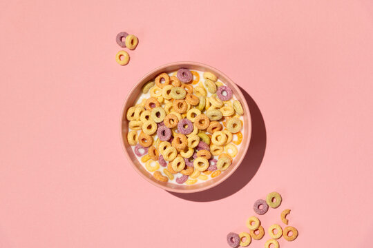 Colorful rings / loops breakfast cereal on pink background
