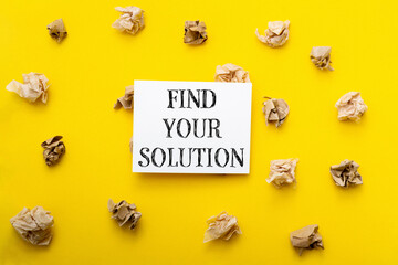 A yellow background with a white sign that says find your solution
