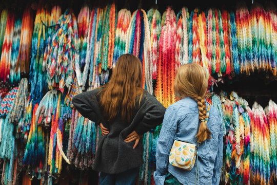 Boy and girl standing in front of a collection of paper cranes 
