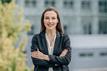 portrait of smiling businesswoman outdoors