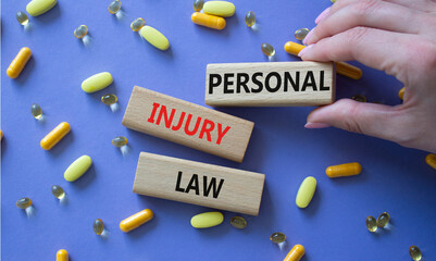 Personal Injury Law symbol. Concept words Personal Injury Law on wooden blocks. Beautiful purple...