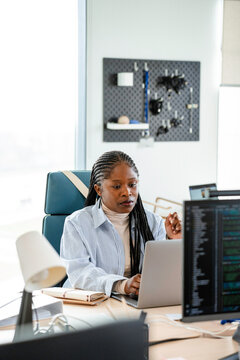 A woman uses a laptop in the office