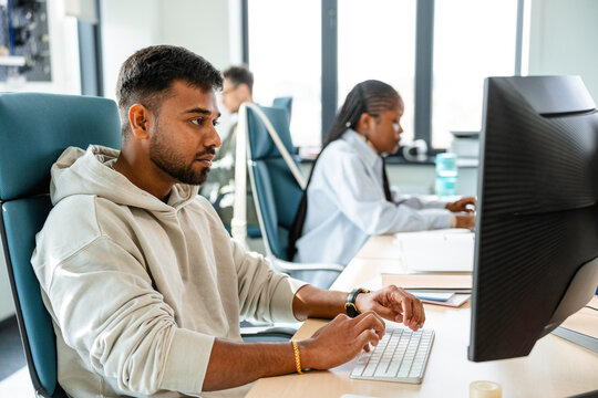 A man uses a computer in the office
