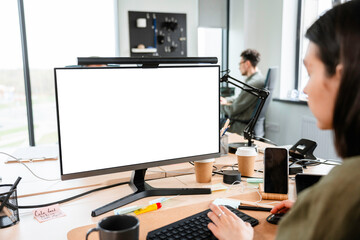 A woman uses a computer with white screen