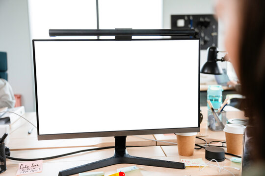 A woman uses a computer with white screen