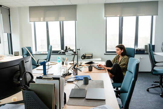 A woman uses a computer in the office