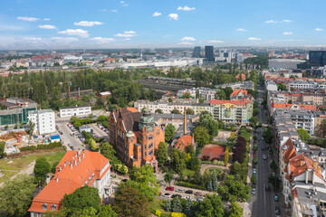 Summer skyline cityscape of district Wilda in Poznan, Poland. Wide panoramic aerial view. Poznań University of Technology building (Politechnika Poznańska) in the foreground. 