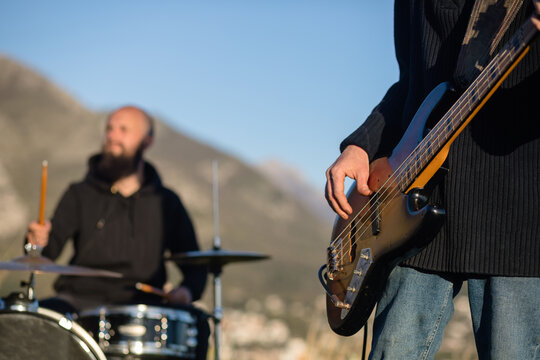Fragment of a bass guitar during a performance outdoors