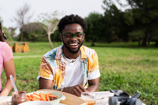 Joyful man enjoying outdoor picnic