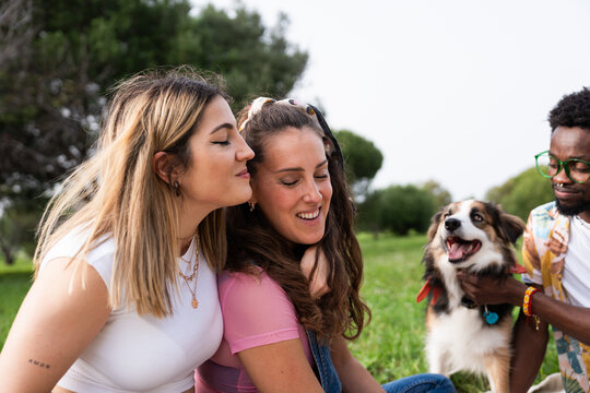 Friends enjoying time with dog in park
