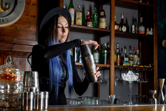 Bartender prepares cocktail at the bar counter