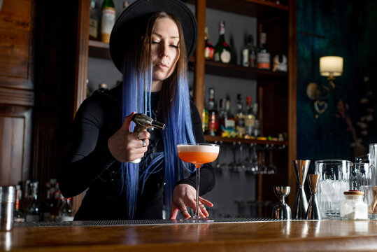 Bartender prepares cocktail at the bar counter