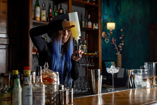 Bartender prepares cocktail at the bar counter