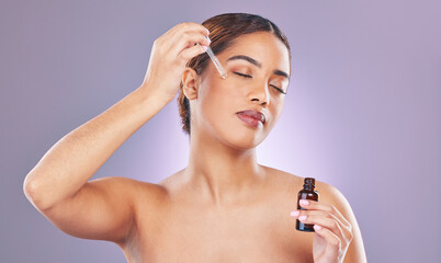 Obraz premium Woman, skincare and serum with dropper for beauty, product and hydration on studio background. Face oil, cosmetic and dermatology for hyaluronic acid, application and collagen facial for person