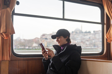Tourist With Phone On A Boat In Istanbul.