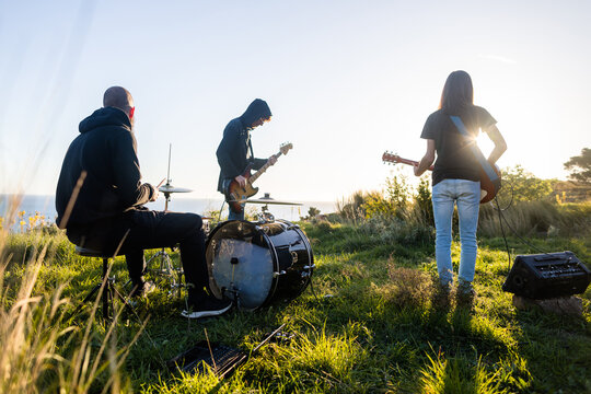Rock band rehearsing outdoors