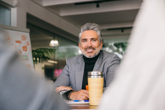 Confident senior businessman in modern office setting