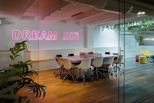 Modern office interior with motivational neon sign
