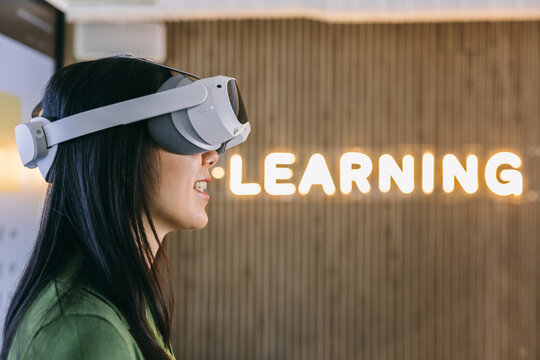 Virtual reality learning with enthusiastic young woman