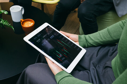 Casual market analysis with a tablet and coffee