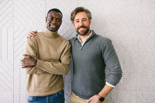 Diverse colleagues smiling in a warm friendly embrace