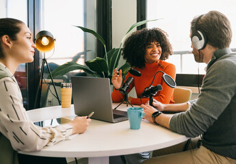 Podcast recording session with diverse co-hosts in studio