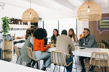 Diverse group of friends enjoying a meal at a modern cafe