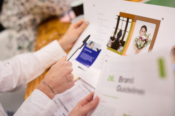 Close-up of Hands Over Brand Guidelines Document