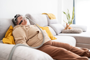 Woman sleeping with CPAP mask.