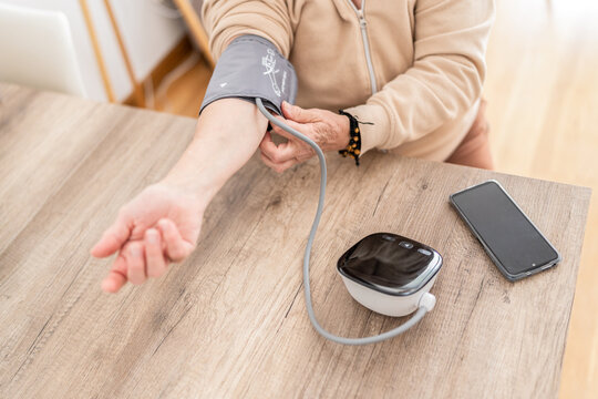 Woman checking blood pressure at home.