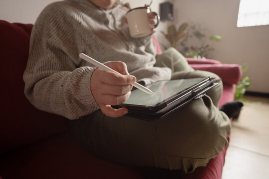 Designer works remotely by drawing in his home on digital tablet