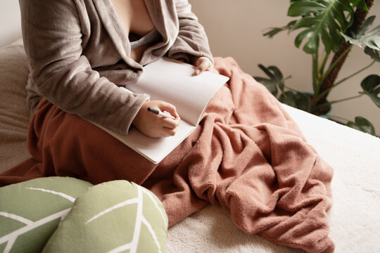 Creative writer with notebook, planning schedule in morning routine 