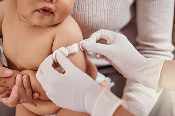 Mother, nurse and baby with plaster on arm for wellness check, medical health and testing in clinic. Woman, child and hospital exam together for immune system development, skincare and protection