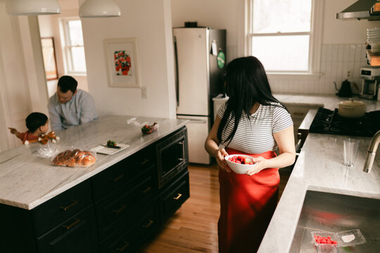 family with pregnant mother in kitchen 