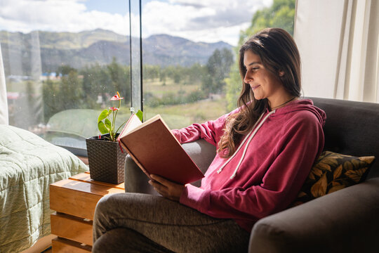 woman reading a book at home