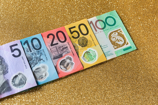 Australian bills of different denominations arranged in a row