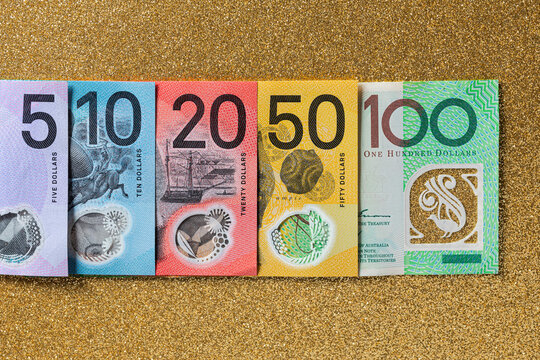 Australian money of different denominations arranged in a row