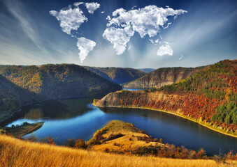 clouds in the form of a world map over the river canyon. Travel and landscape concept. autumn...