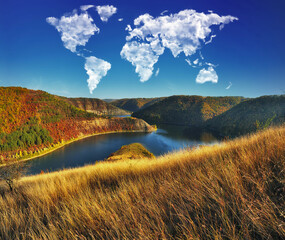 clouds in the form of a world map over the river canyon. Travel and landscape concept. autumn...