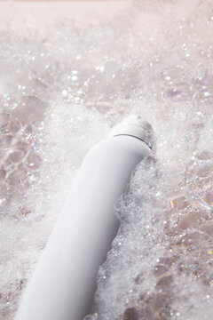 Shower product surrounded by foam bubbles