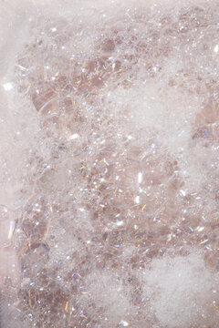 Shower product surrounded by foam bubbles