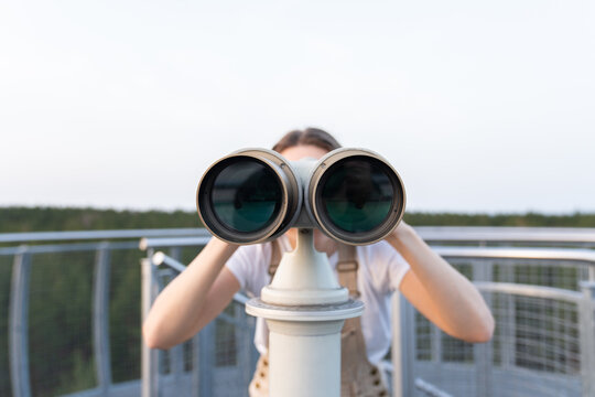 Woman Using Binoculars At Viewpoint