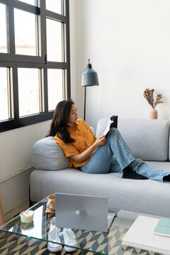 woman read book at home